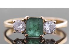 Emerald and diamond three stone ring centring a rectangular cut emerald, 6.16 x 5.12 x 3.6mm,