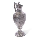 Victorian silver claret jug of tapering baluster form to a shaped circular foot, rococo style