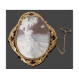 Victorian carved shell cameo brooch, oval form, depicting a shepherdess, in a decorative gilt