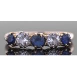 Sapphire and diamond five stone ring, alternate set with three round faceted sapphires and two round