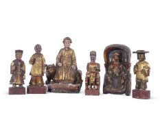 Group of six wooden Chinese immortals or deities, all with painted gilt designs on rectangular bases