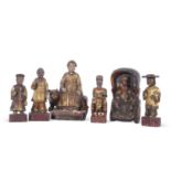 Group of six wooden Chinese immortals or deities, all with painted gilt designs on rectangular bases