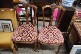 PAIR OF LATE VICTORIAN AMERICAN WALNUT FRAMED DINING CHAIRS WITH RED UPHOLSTERED SEATS