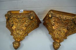 PAIR OF MODERN COMPOSITION GILT FINISH WALL BRACKETS WITH RAMS HEAD DETAIL