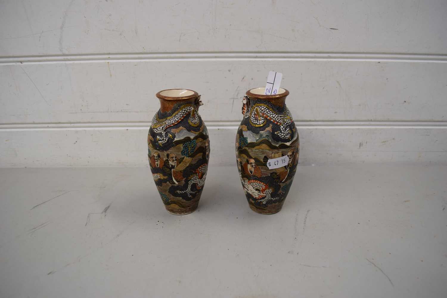 PAIR OF SMALL JAPANESE SATSUMA VASES DECORATED WITH FIGURES AND DRAGONS