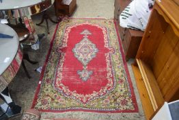 20TH CENTURY FLORAL DECORATED WOOL RUG WITH LARGE RED CENTRAL PANEL, 200CM WIDE