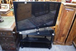 LG FLAT SCREEN TV WITH BLACK GLASS STAND
