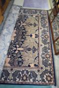 MODERN WOOL FLOOR RUG DECORATED WITH LARGE FLORAL DESIGN ON A BLUE BACKGROUND, 198CM WIDE