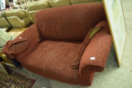 RED TWO-SEATER SOFA RAISED ON TURNED LEGS