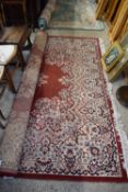 MODERN FLOOR RUG DECORATED WITH FLORAL DETAIL ON A RED BACKGROUND, 140CM WIDE