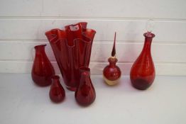 MIXED LOT OF VARIOUS RED GLASS WARES TO INCLUDE A HANDKERCHIEF TYPE VASE, VARIOUS JUGS AND DECANTER