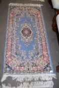 SMALL WOOL FLOOR RUG WITH BLUE CENTRAL PANEL WITH FLORAL BORDER, 140CM LONG