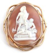 Victorian large carved shell cameo brooch depicting a family group standing with a man lying down,
