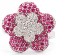 Modern diamond and ruby cluster ring, a large flowerhead design set throughout with small diamonds