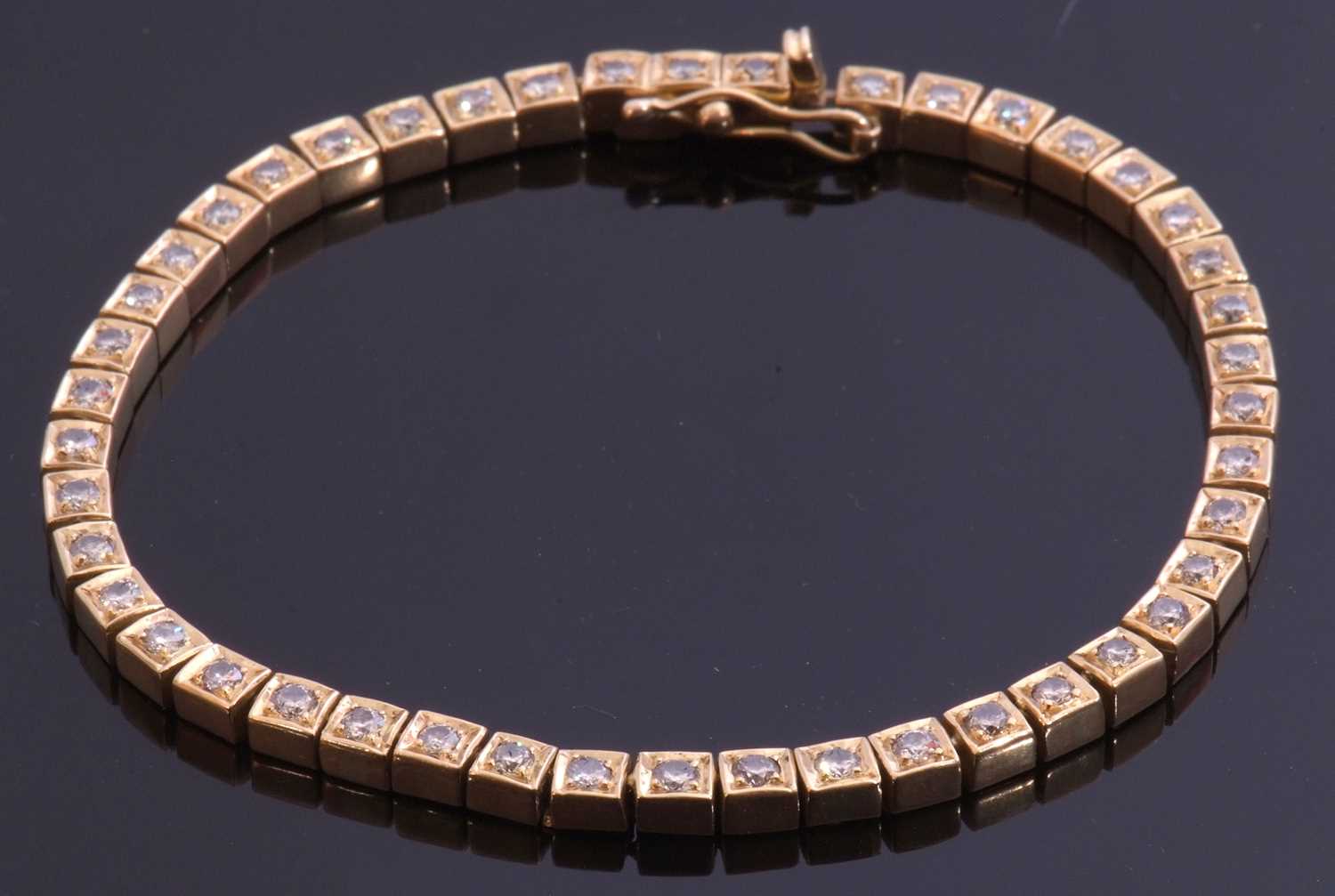 Diamond line bracelet featuring 45 small diamonds, individually claw set in articulated box
