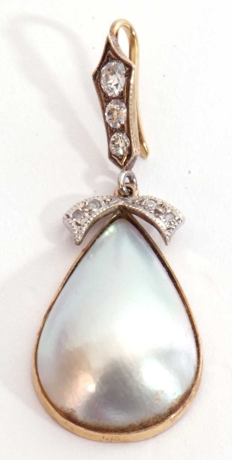 Nacre shell and diamond set pendant, the drop shell pendant framed in a 9ct gold mount, London 1982,