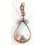 Nacre shell and diamond set pendant, the drop shell pendant framed in a 9ct gold mount, London 1982,