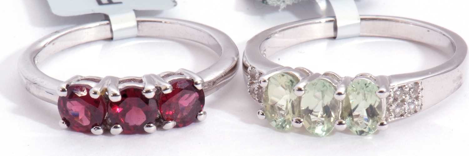 Mixed Lot: a Rajasthan garnet three stone ring, a lemon amblygonite and white topaz ring, both