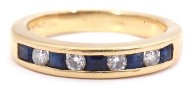 Diamond and sapphire half hoop ring, alternate channel set with four round brilliant cut diamonds