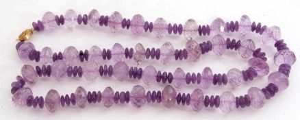 Large amethyst bead necklace, a single row of faceted and polished beads to a silver gilt clasp,