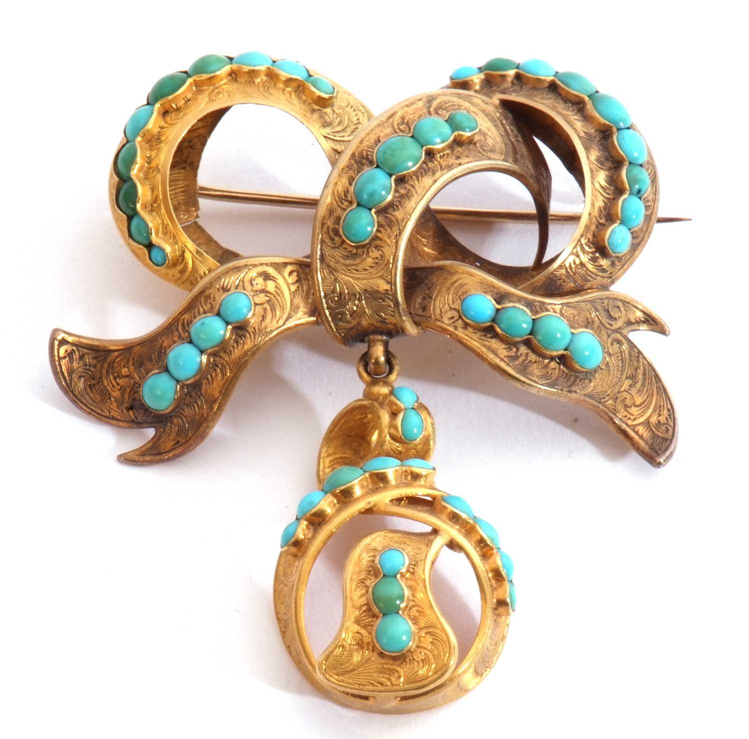Antique gold and turquoise brooch, a tied ribbon design suspending a knotted ribbon, set
