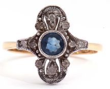 Modern 18ct gold sapphire and diamond set ring, centring a round cut sapphire in a rub-over