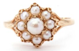 Modern 9ct gold seed pearl cluster ring, the centre pearl 5mm diam, and raised within a small seed