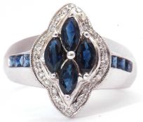 Modern sapphire and diamond cluster ring featuring four marquis shaped synthetic sapphires within