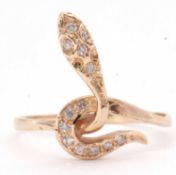 Modern diamond snake ring, the head and tail highlighted with small single cut diamonds, stamped