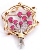 Large precious metal open work brooch, a design featuring a spray of flowers set with eight pink