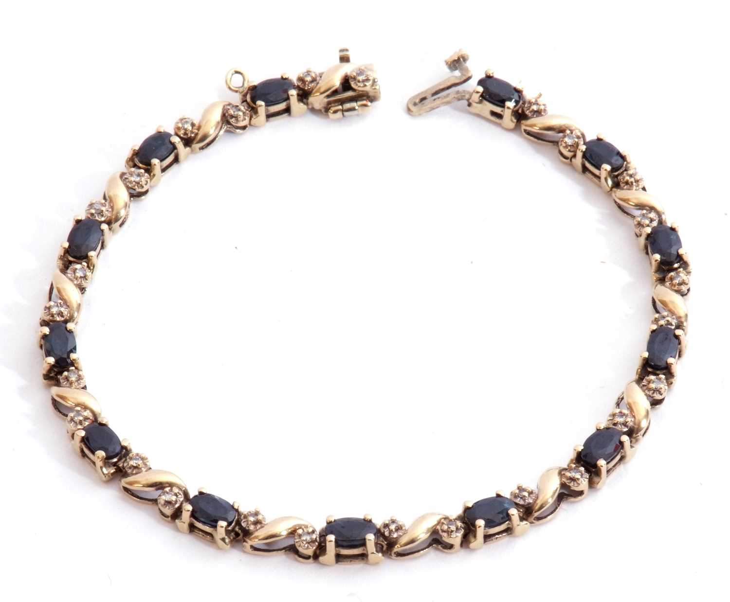 Sapphire and diamond line bracelet, alternate set with 13 oval shaped dark sapphires and 26 small