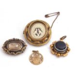 Mixed Lot: Victorian banded agate mourning brooch, a Victorian gilt metal black enamel mourning