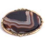 Antique large banded agate brooch, 65 x 50mm, oval shape and framed in a plain scroll yellow metal