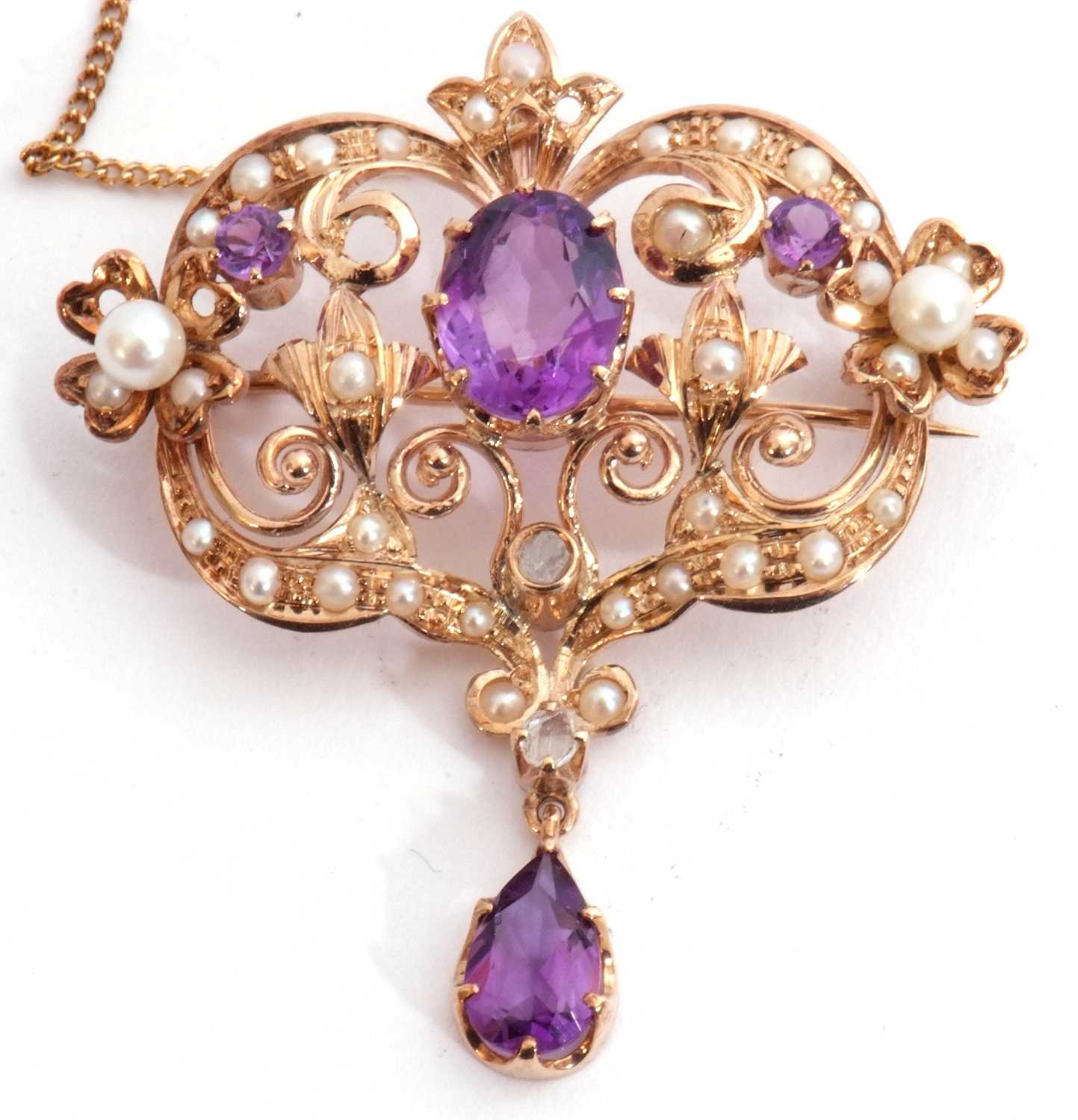 Amethyst, pearl and diamond open work brooch/pendant centring an oval faceted amethyst raised in
