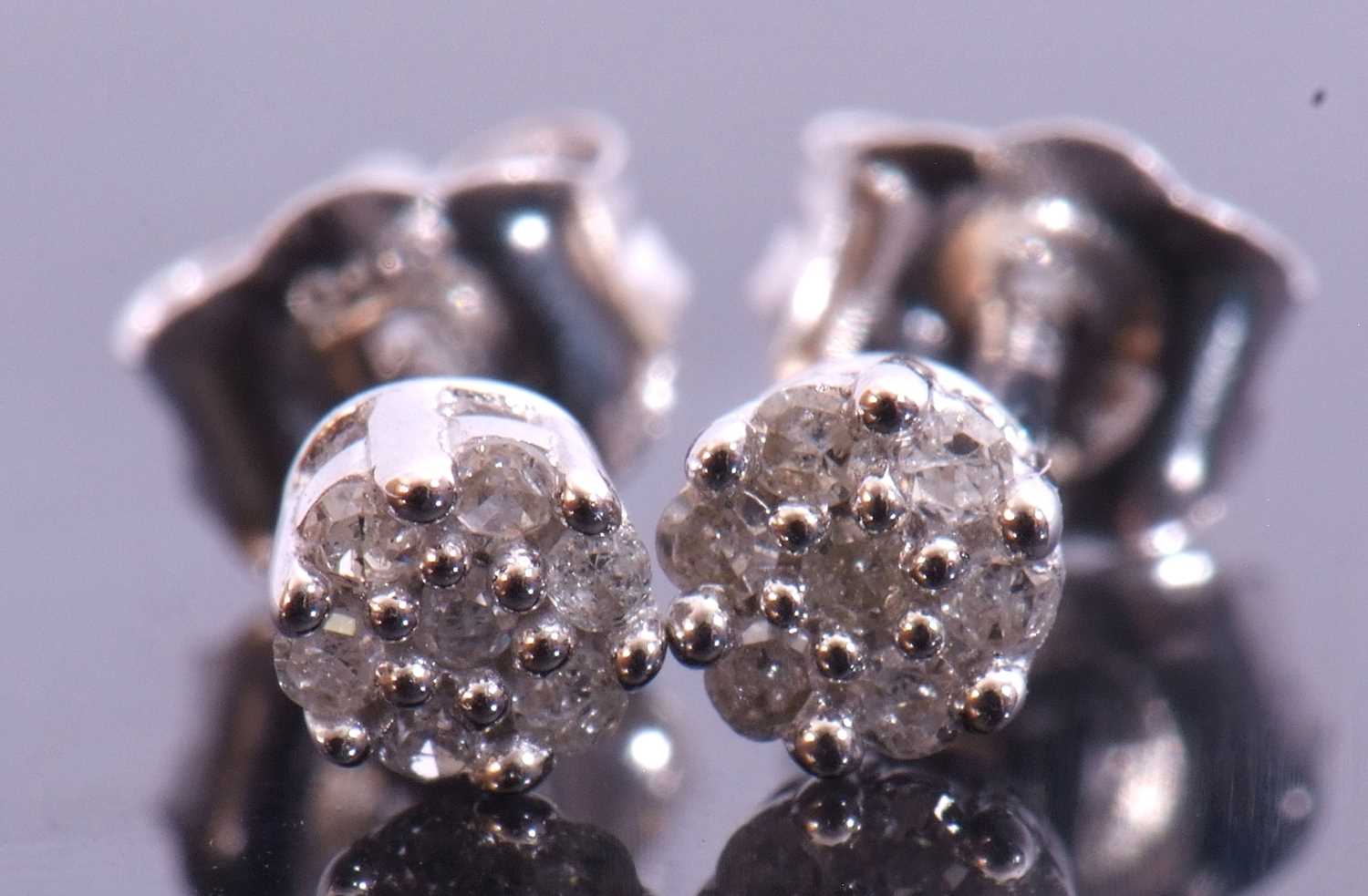 Pair of small diamond stud earrings, a flowerhead design featuring 7 small single cut diamonds in - Image 2 of 2