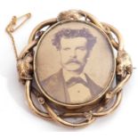 Victorian brooch, a sepia print depicting a one-eyed gentleman in an ornate scrolled gilt metal