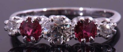 Diamond and ruby five stone ring centring a round brilliant cut diamond between alternate set