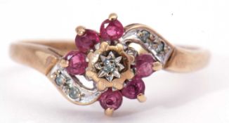 9ct gold ruby and diamond cluster ring, centring a small diamond in a star engraved illusion