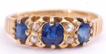 Victorian sapphire and diamond ring featuring three oval cut sapphires, highlighted between with