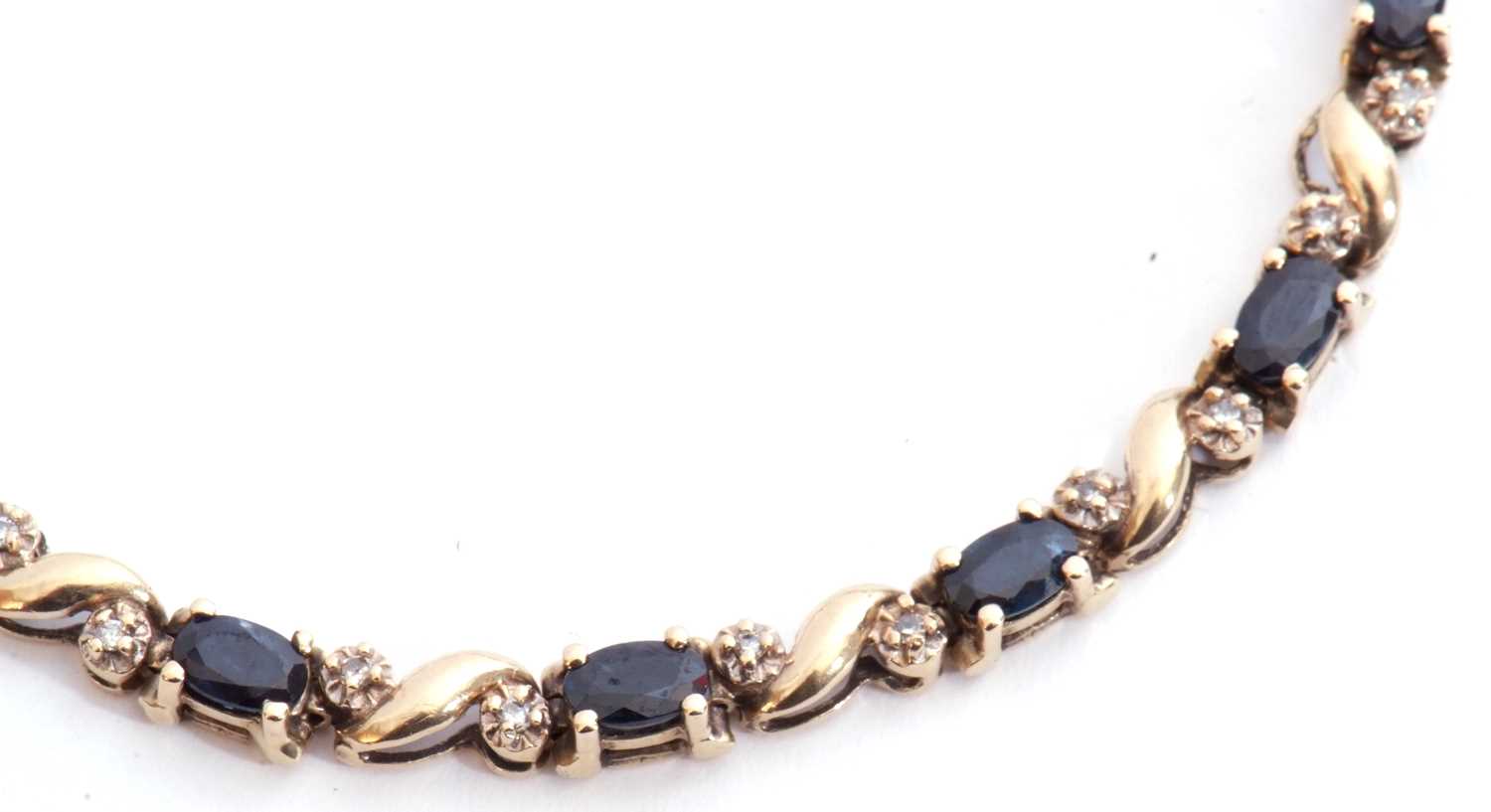 Sapphire and diamond line bracelet, alternate set with 13 oval shaped dark sapphires and 26 small - Image 5 of 5
