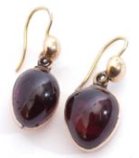 Vintage garnet set earrings, a cabochon teardrop garnet in cut down yellow metal mount suspended