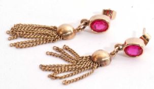 Pair of ruby tassel earrings, the bezel set synthetic rubies suspending a circular disc and tassel