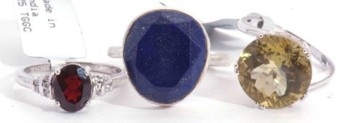 Mixed Lot: lapis lazuli dress ring, an olive quartz dress ring, together with a garnet and white