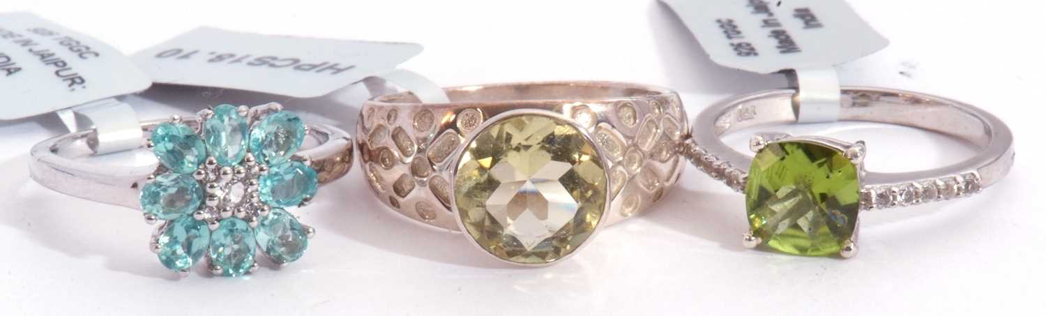Mixed Lot: lemon quartz dress ring, a peridot and white topaz ring, together with an apatite and