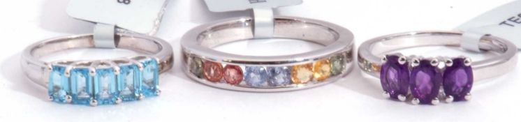 Mixed Lot: Swiss blue topaz five stone ring, a half hoop fancy sapphire ring, together with a Kalomo