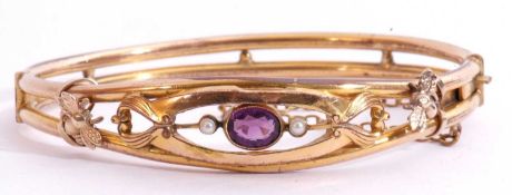 Gold plated open work hinged bracelet, the top section with a purple stone and small seed pearl