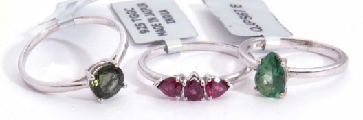 Mixed Lot: rhodolite three stone garnet ring, a moldavite ring, together with a fern green topaz