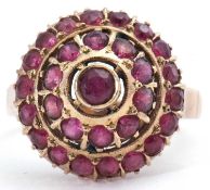 Modern dome shaped ruby cluster ring, a three tier design, to a plain shank, stamped 18K, size P
