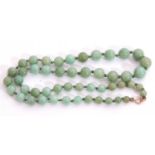 Single row of graduated pale green jade beads, 3-6mm diam, 22cm long, fastened