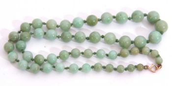 Single row of graduated pale green jade beads, 3-6mm diam, 22cm long, fastened